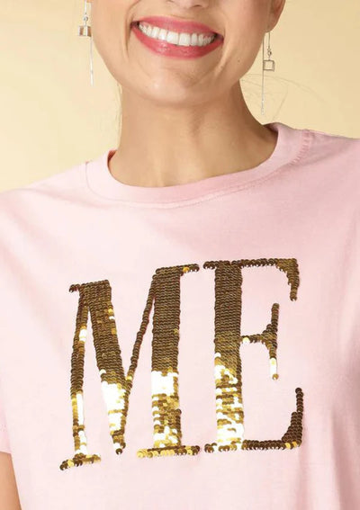 Close-up of reversible sequin design on Pink T-shirt showing color change from Red to Gold