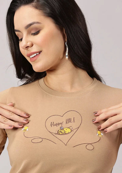 Close-up of bee embroidery on Happy Be T-shirt for women