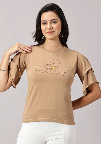 Close-up of bee embroidery on Happy Be T-shirt