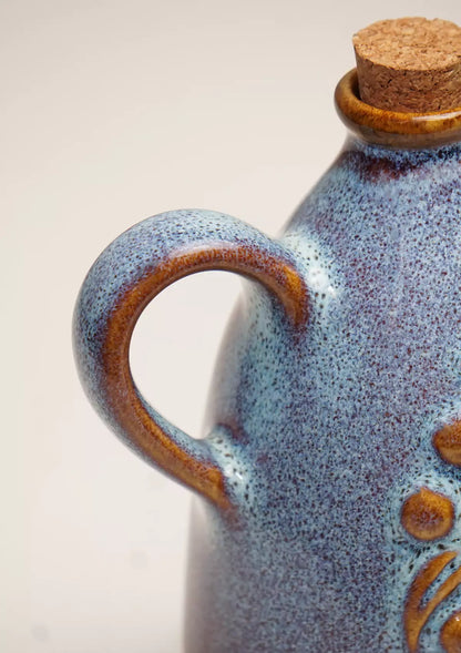 Ceramic oil bottle with blue speckled glaze and cork lid